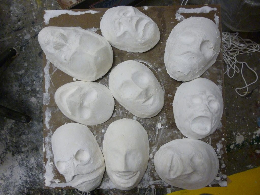 The Happy Mask Salesman's Masks Before Paint